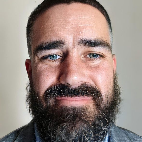 Headshot of a man with short hair and a beard.